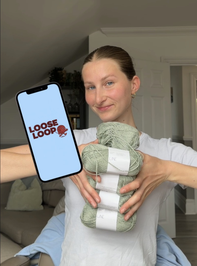 Nina holding yarn and a phone showing LooseLoop